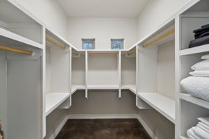 Second of two primary walk-in closets for him and her.