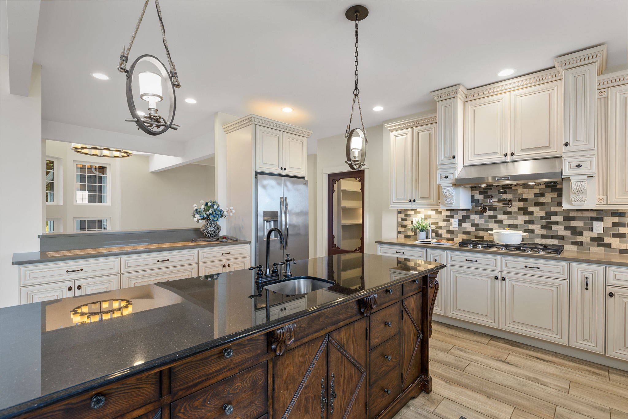 Beautiful statement island with prep sink, walk in pantry, propane cooktop with pot filler and gorgeous custom cabinetry.