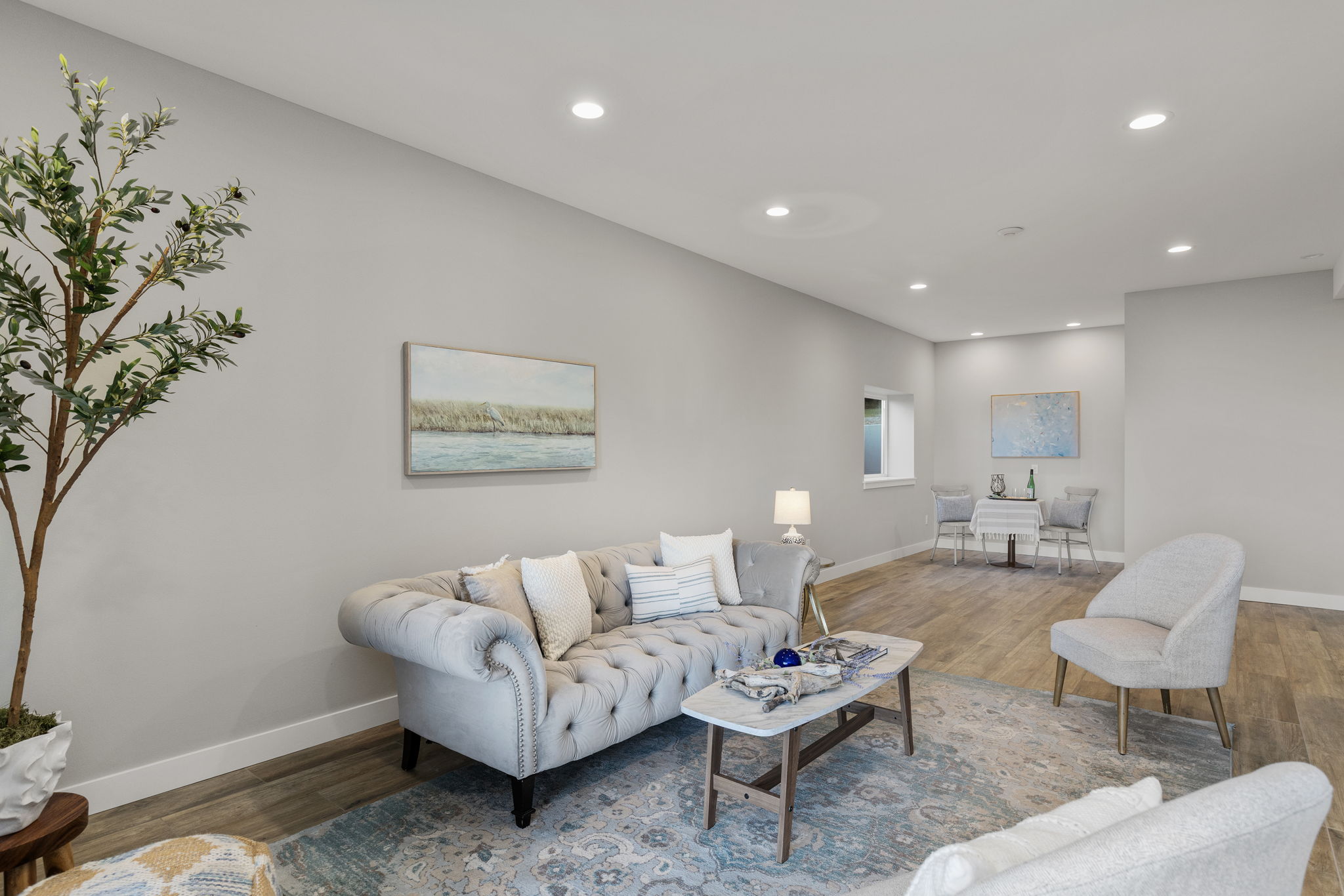 Another shot of lower level living space/ rec room with water views and covered patio access.