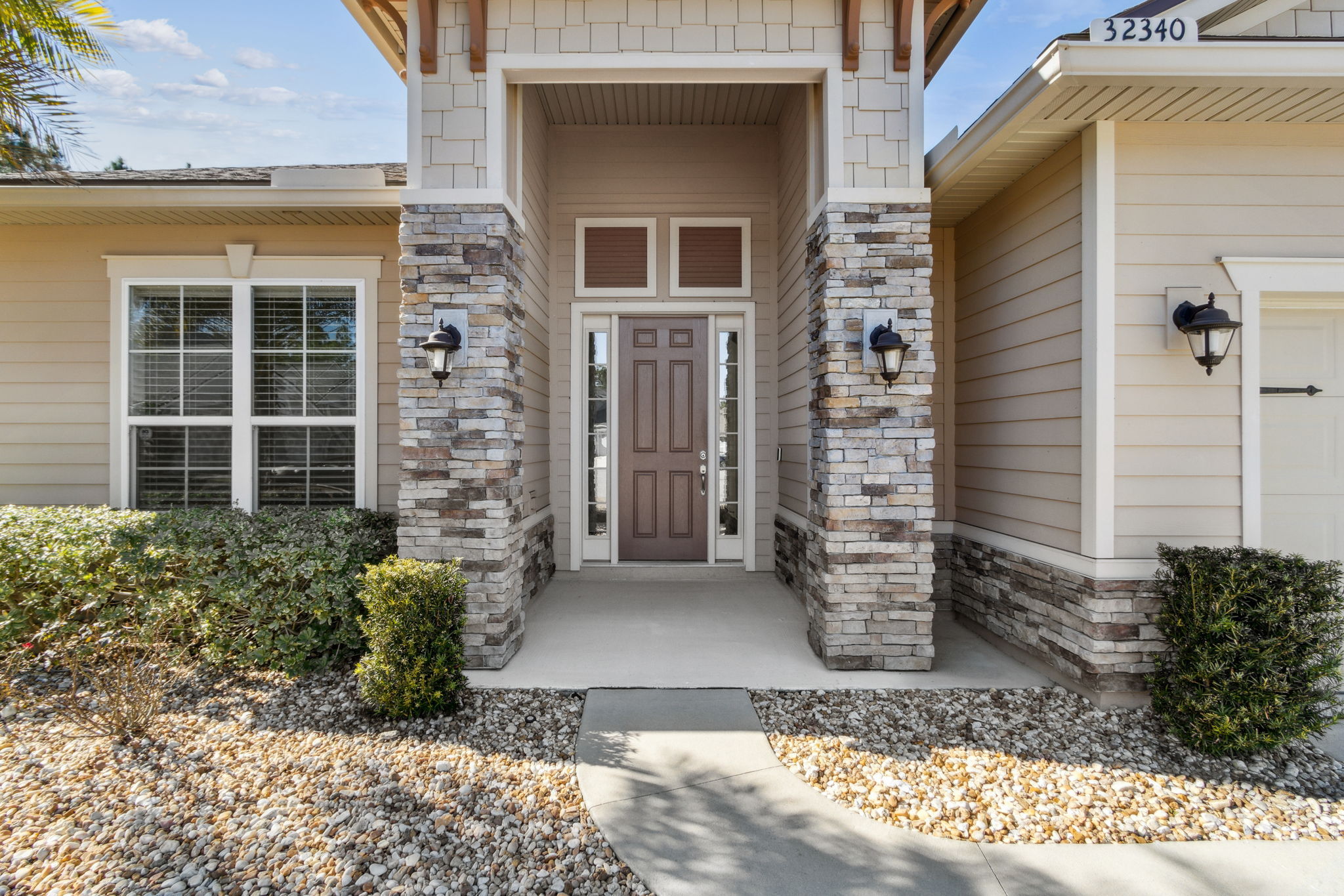 Enter through a covered stone-accented portico...