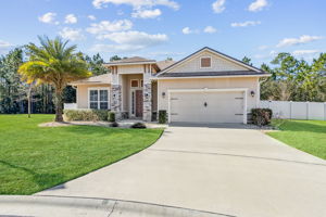 ... featuring varied rooflines and elegant stone accents.