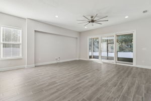 Highlights of the family room are a glass wall framing the backyard’s natural beauty...