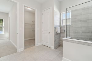 The massive walk-in closet conveniently connects the primary bath to the bedroom ...