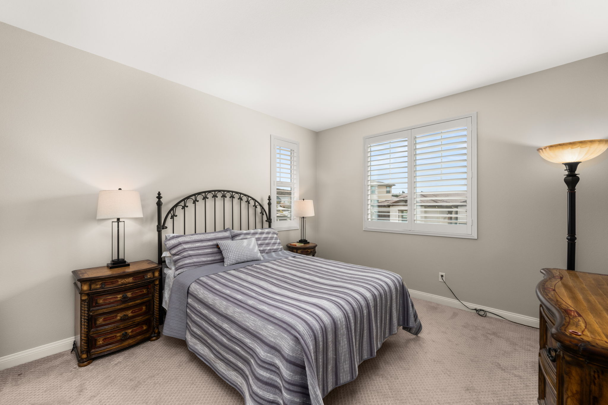 Two good sized secondary bedrooms each feature upgraded carpet and custom shutters