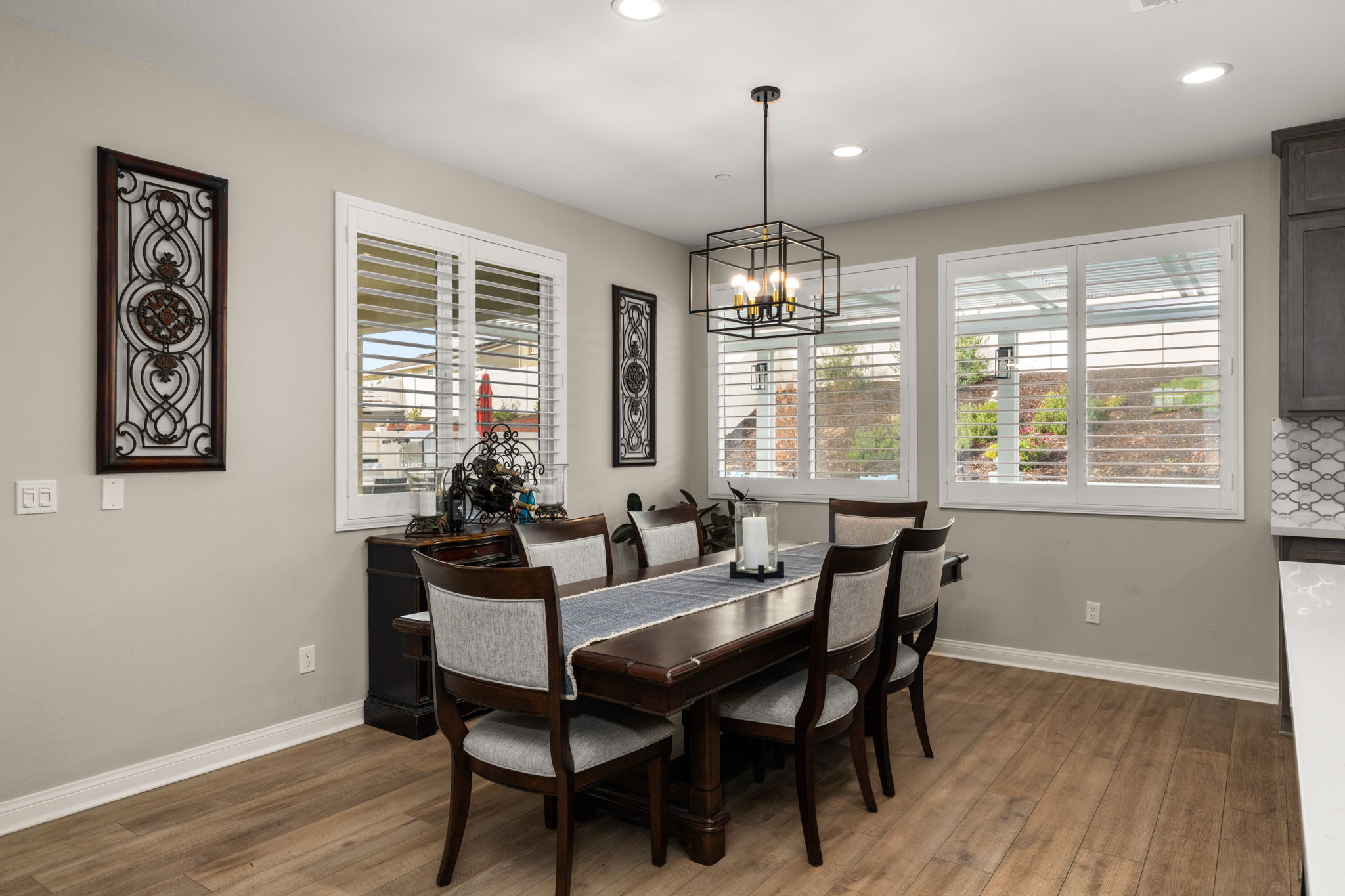 Inside features upgraded flooring, custom paint, and shutters throughout