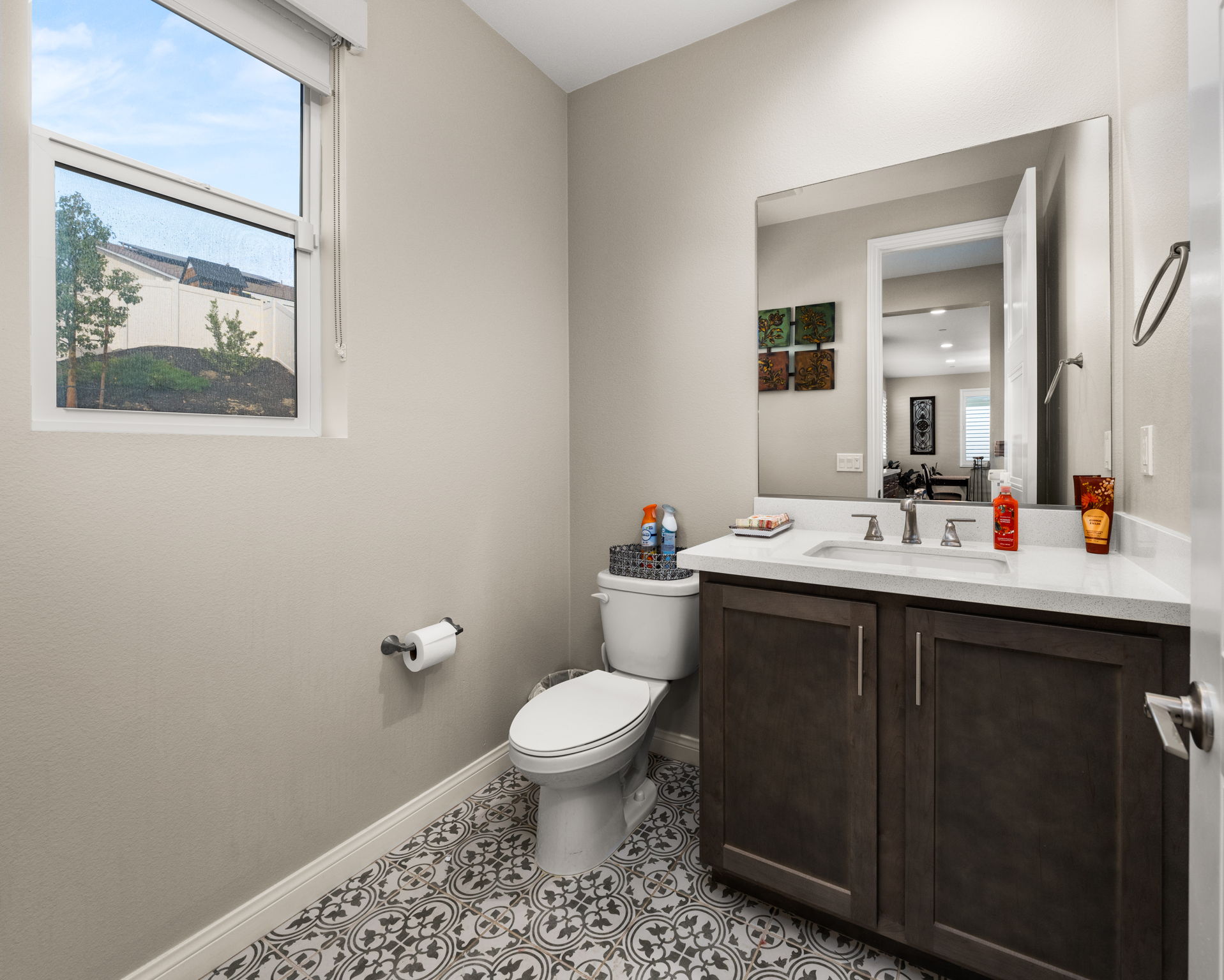 Downstairs powder room features upgraded designer tile flooring