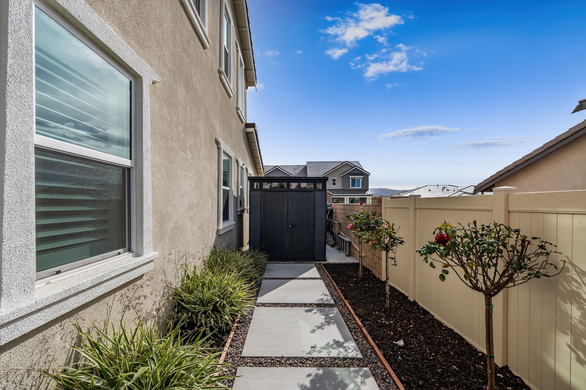 Fully landscaped backyard with storage shed