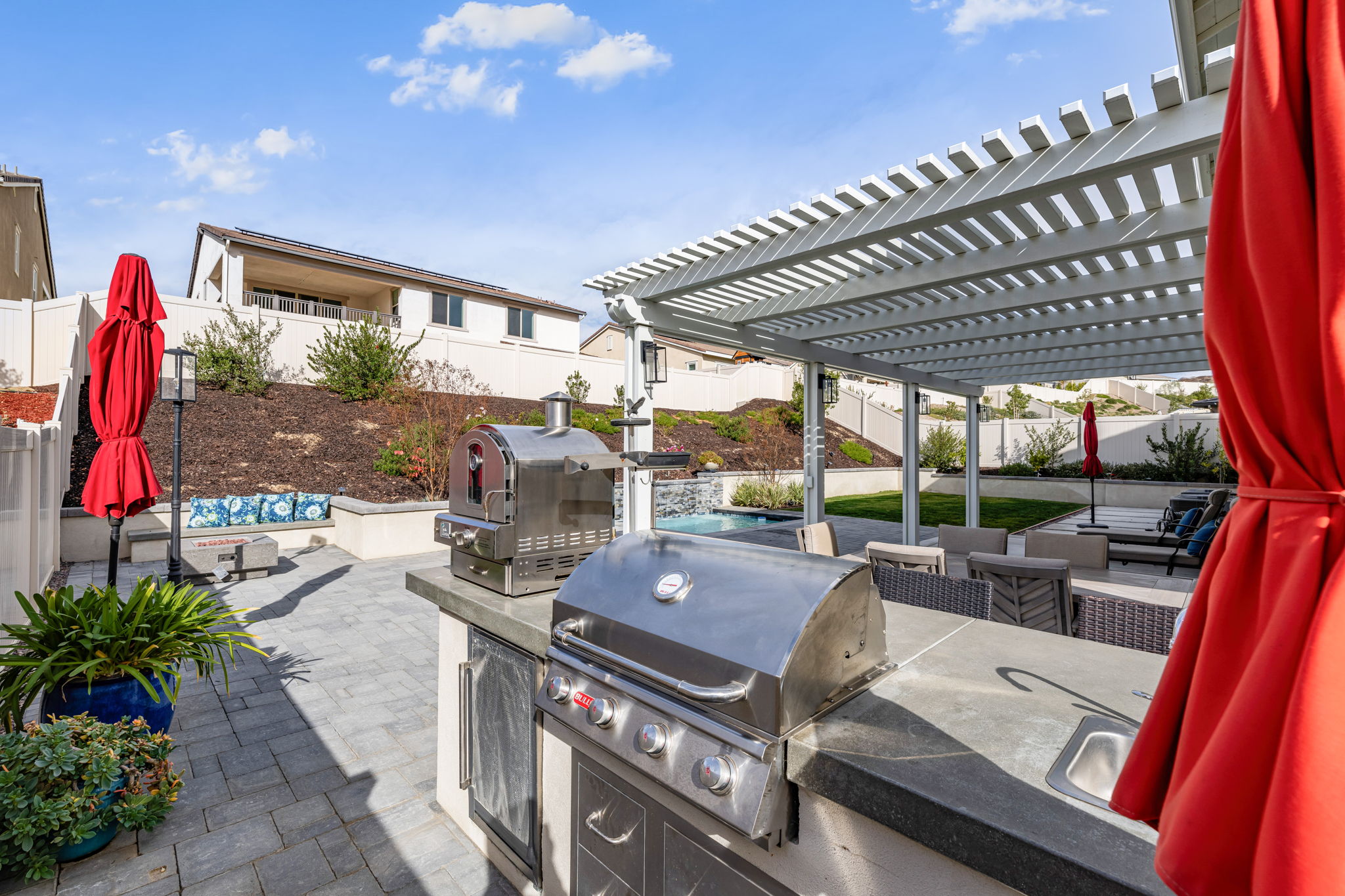 Backyard is an entertainer's dream, featuring a sparkling "spool" (spa/mini pool) with waterfall feature; built in fire pit with built in benches; built in natural gas BBQ island with sink and fridge; pavers & outdoor fans; built in outdoor surround sound speakers