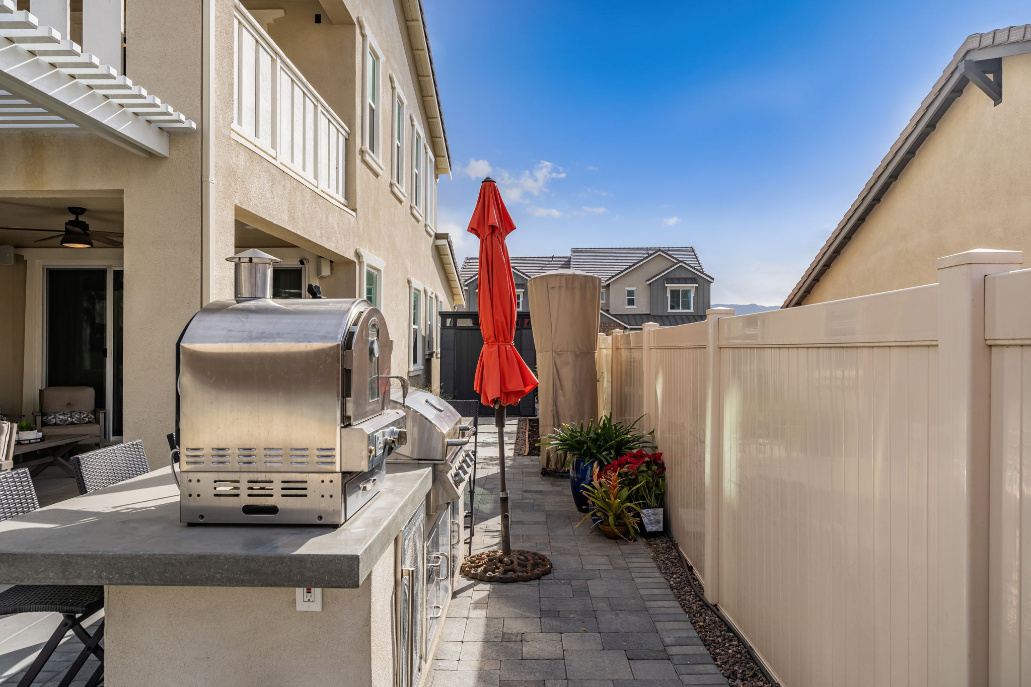 Backyard is an entertainer's dream, featuring a sparkling "spool" (spa/mini pool) with waterfall feature; built in fire pit with built in benches; built in natural gas BBQ island with sink and fridge; pavers & outdoor fans; built in outdoor surround sound speakers