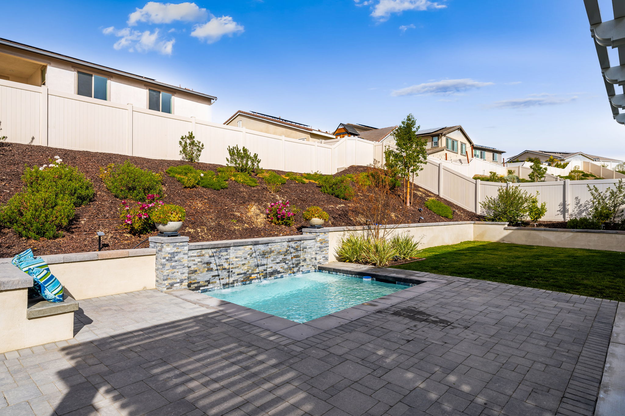 Backyard is an entertainer's dream, featuring a sparkling "spool" (spa/mini pool) with waterfall feature; built in fire pit with built in benches; built in natural gas BBQ island with sink and fridge; pavers & outdoor fans; built in outdoor surround sound speakers