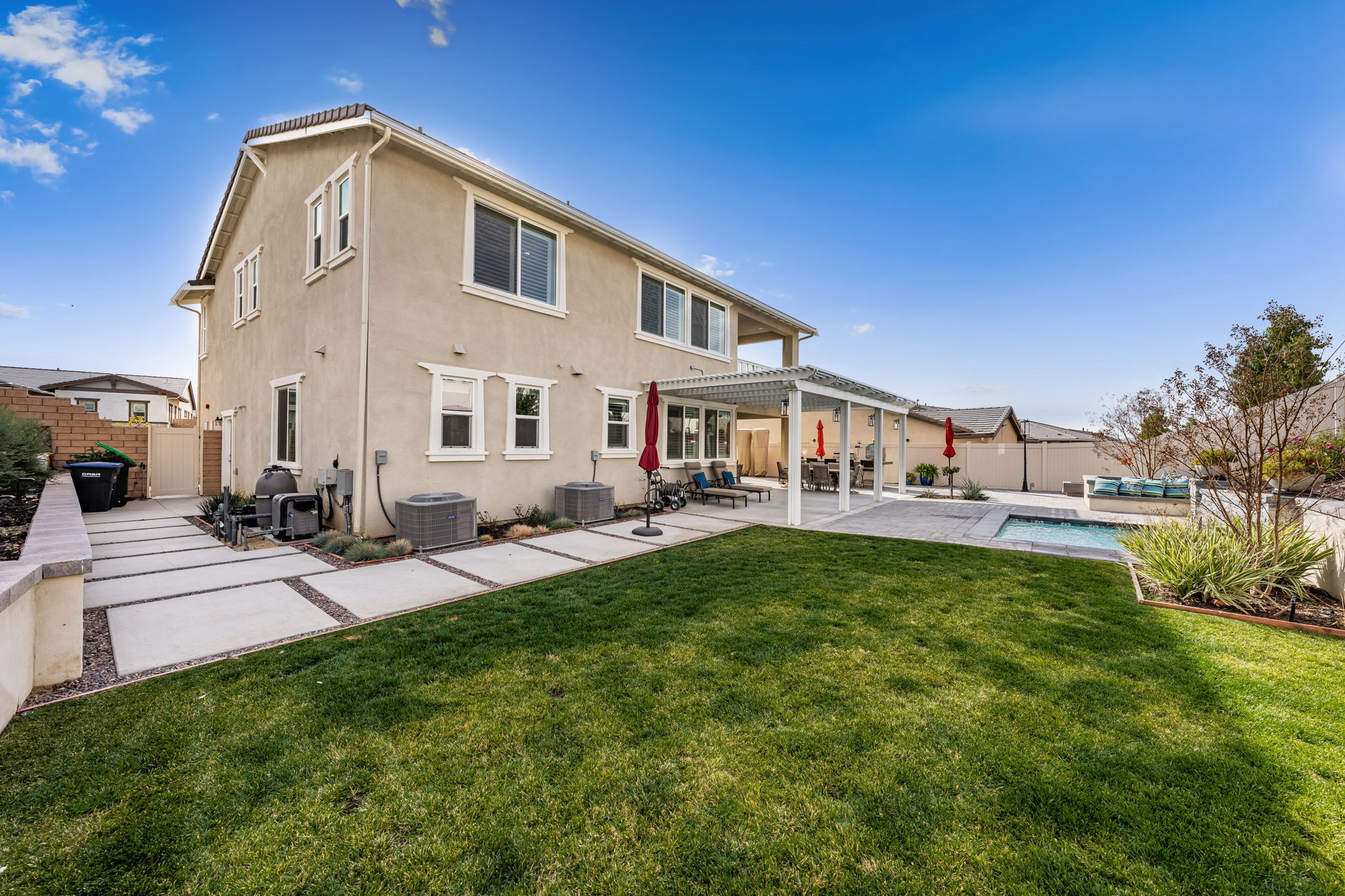 Backyard is an entertainer's dream, featuring a sparkling "spool" (spa/mini pool) with waterfall feature; built in fire pit with built in benches; built in natural gas BBQ island with sink and fridge; pavers & outdoor fans; built in outdoor surround sound speakers