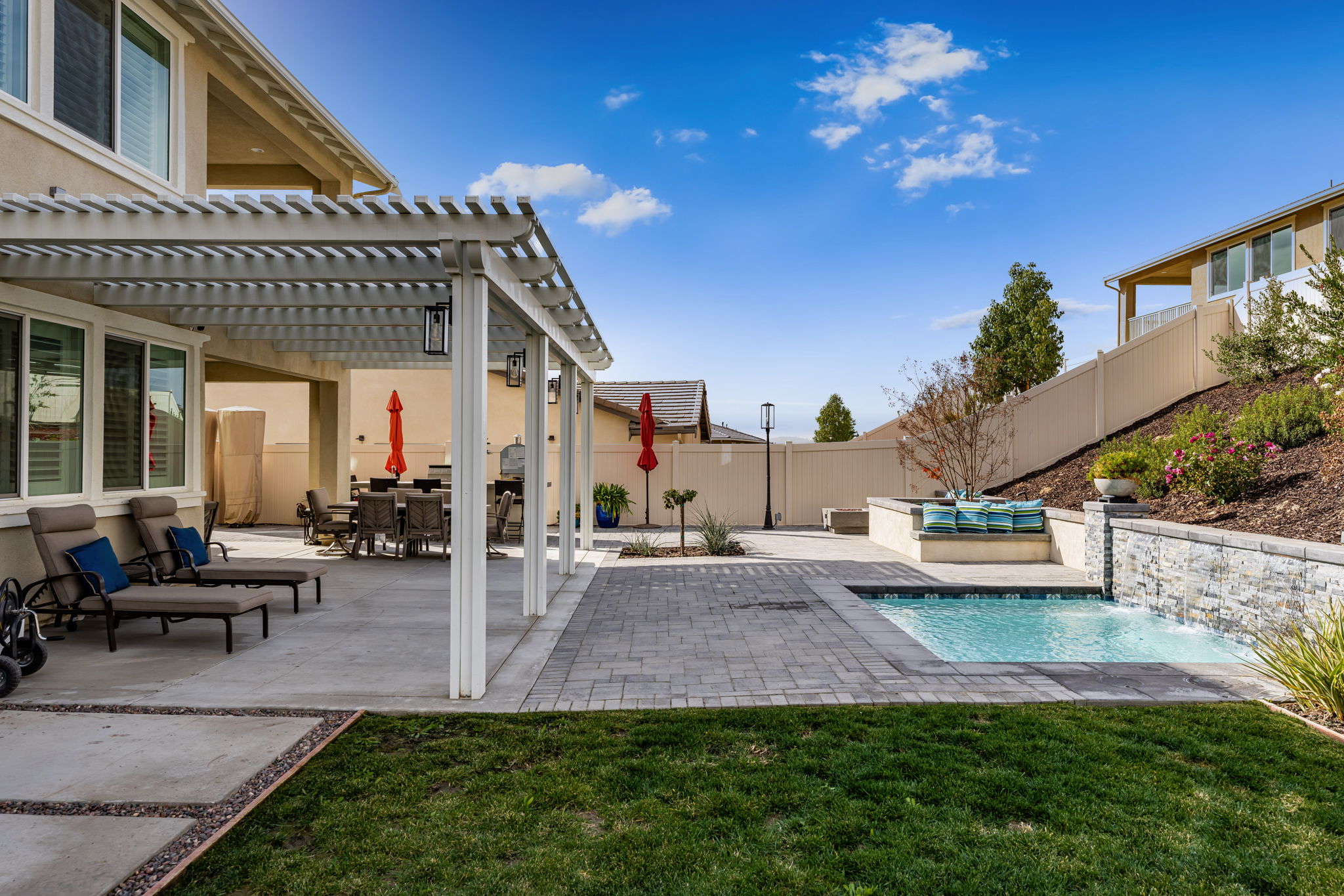 Backyard is an entertainer's dream, featuring a sparkling "spool" (spa/mini pool) with waterfall feature; built in fire pit with built in benches; built in natural gas BBQ island with sink and fridge; pavers & outdoor fans; built in outdoor surround sound speakers