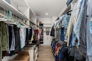 Primary suite features custom closets