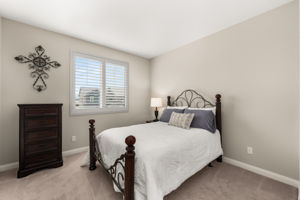 Two good sized secondary bedrooms each feature upgraded carpet and custom shutters