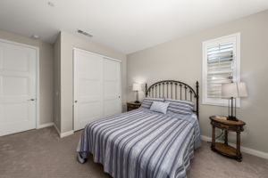 Two good sized secondary bedrooms each feature upgraded carpet and custom shutters