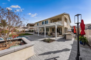 Backyard is an entertainer's dream, featuring a sparkling "spool" (spa/mini pool) with waterfall feature; built in fire pit with built in benches; built in natural gas BBQ island with sink and fridge; pavers & outdoor fans; built in outdoor surround sound speakers