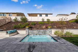 Backyard is an entertainer's dream, featuring a sparkling "spool" (spa/mini pool) with waterfall feature; built in fire pit with built in benches; built in natural gas BBQ island with sink and fridge; pavers & outdoor fans; built in outdoor surround sound speakers