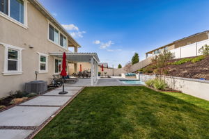 Backyard is an entertainer's dream, featuring a sparkling "spool" (spa/mini pool) with waterfall feature; built in fire pit with built in benches; built in natural gas BBQ island with sink and fridge; pavers & outdoor fans; built in outdoor surround sound speakers