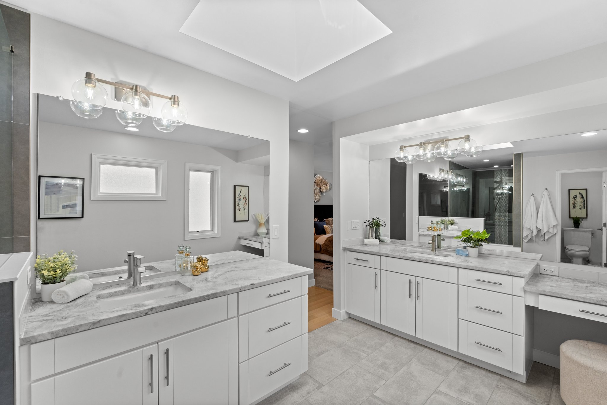 Primary bath has dual sinks and natural quartz counters