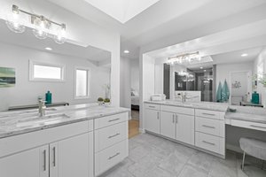 Primary bath has dual sinks and natural quartz counters