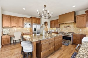 Large, stunning kitchen with granite countertops and bar stool seating