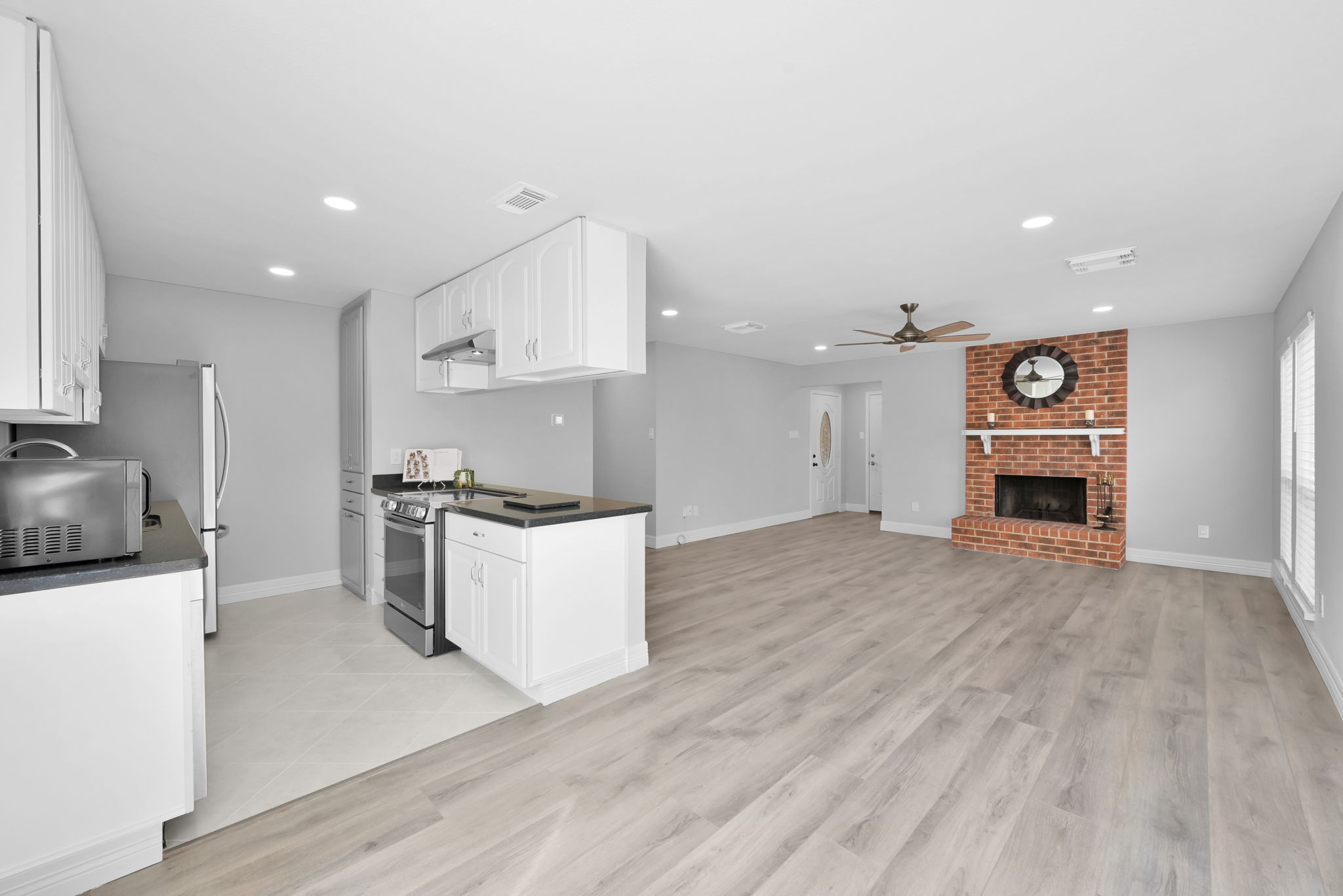 Home's entire interior has recent fresh paint. Ceiling Fans and recessed lighting are in all main living areas of the home.