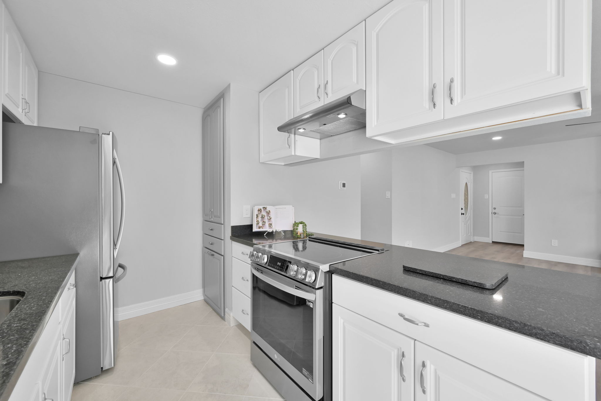 Love that this kitchen is open to the Living Room. Notice the ADDED PANTRY AREA at the very end on the right.