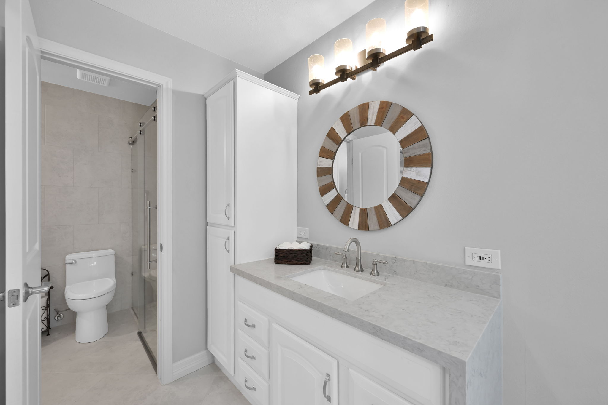 PRIMARY BEDROOM BATHROOM VANITY w/ access to walk-in shower. Love the built-in LINEN CABINET and decorative mirror!