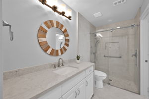 This bath is off the main hallway (shower area is shared w/ vanity area in primary BR). Beautifully updated w/ new Quartz CTs, new lighting and large Walk-in Shower.