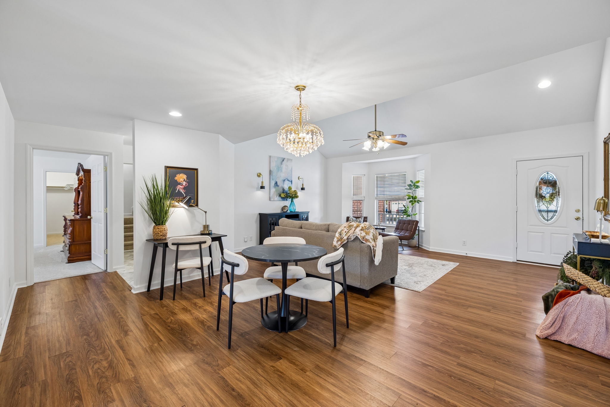 View of combo dining/great room from  hallway to zoned owner's suite, drop zone,  bonus room , laundry room, and garage .
