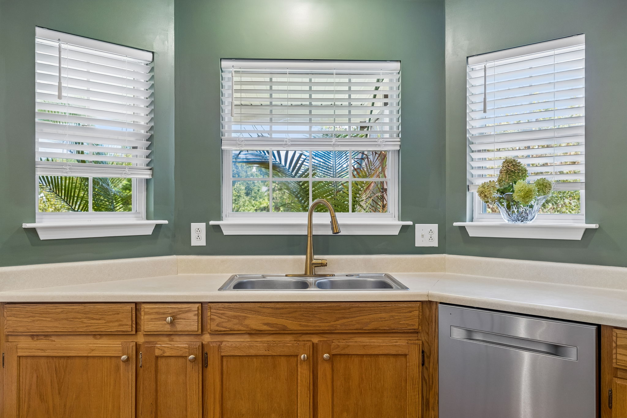Bay window view from double kitchen sink, new cordless blinds throughout house, all new stainless steel appliances.