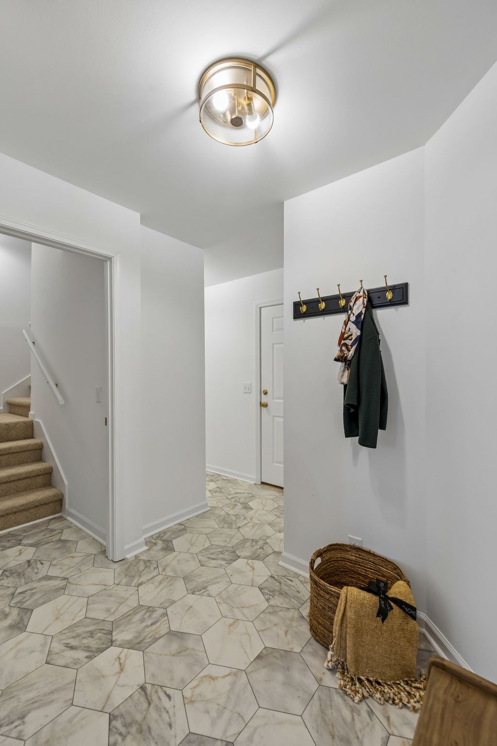 Rare drop zone from garage entry. Laundry area and stairs leading to over the garage bonus room with half bath.