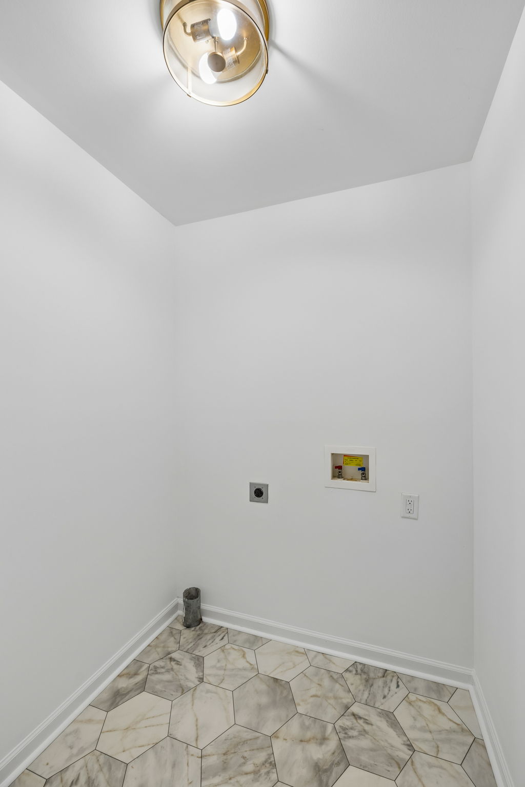 Laundry area with room for cleaning supplies. New  flooring, new paint, new fixtures.