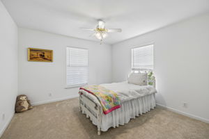 Zoned, main floor secondary bedroom with ceiling fan, new capet/pad, tons of natural light throughout the house.