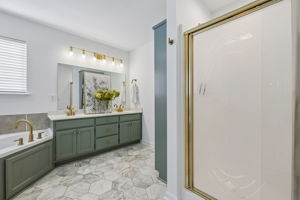 Spacious owner' ensuite with new flooring, separate shower, Jacuzzi tub, double vanities, painted oak cabinets, new brushed gold fixtures, ADA  entry door.