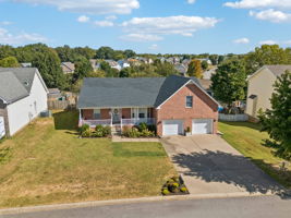 Concrete drive, double garage doors, with extra long garage.