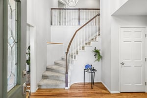 Welcoming front entrance. One of two staircases in this lovely home.