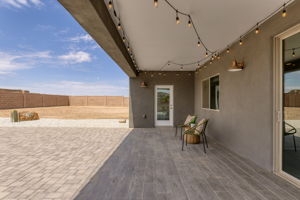 Covered Back Patio with plank tile floors and string lights