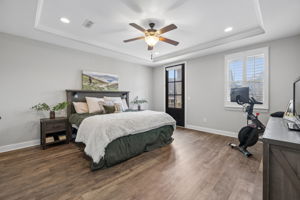 INSTALLED IN PRIMARY BEDROOM. (Updated Pictures forthcoming.)  All bedrooms located upstairs. Tray ceiling, flush-mounted-LED lighting, 6-pane door leads to 2nd floor balcony.