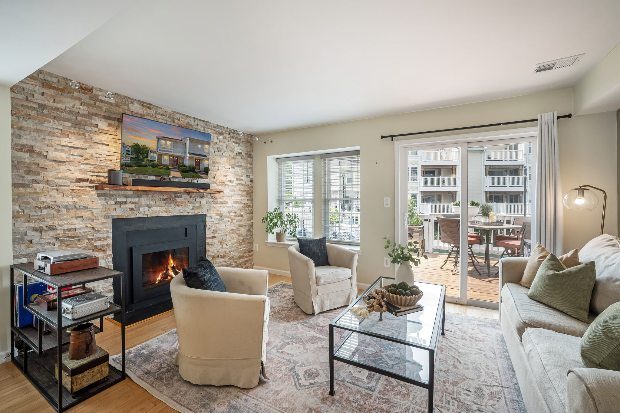 Open Living Room w/modern fireplace & lake views!