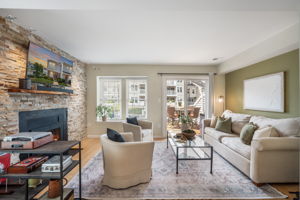 Open Living Room w/modern fireplace & lake views!