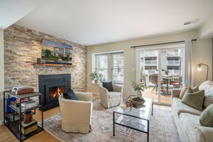 Open Living Room w/modern fireplace & lake views!