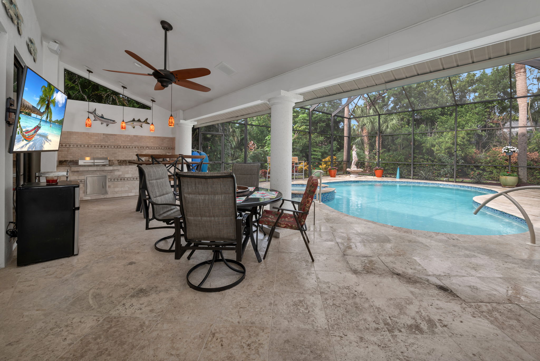 Lanai area is covered and has newer built-in grill, pendant lighting and sealed marble decking