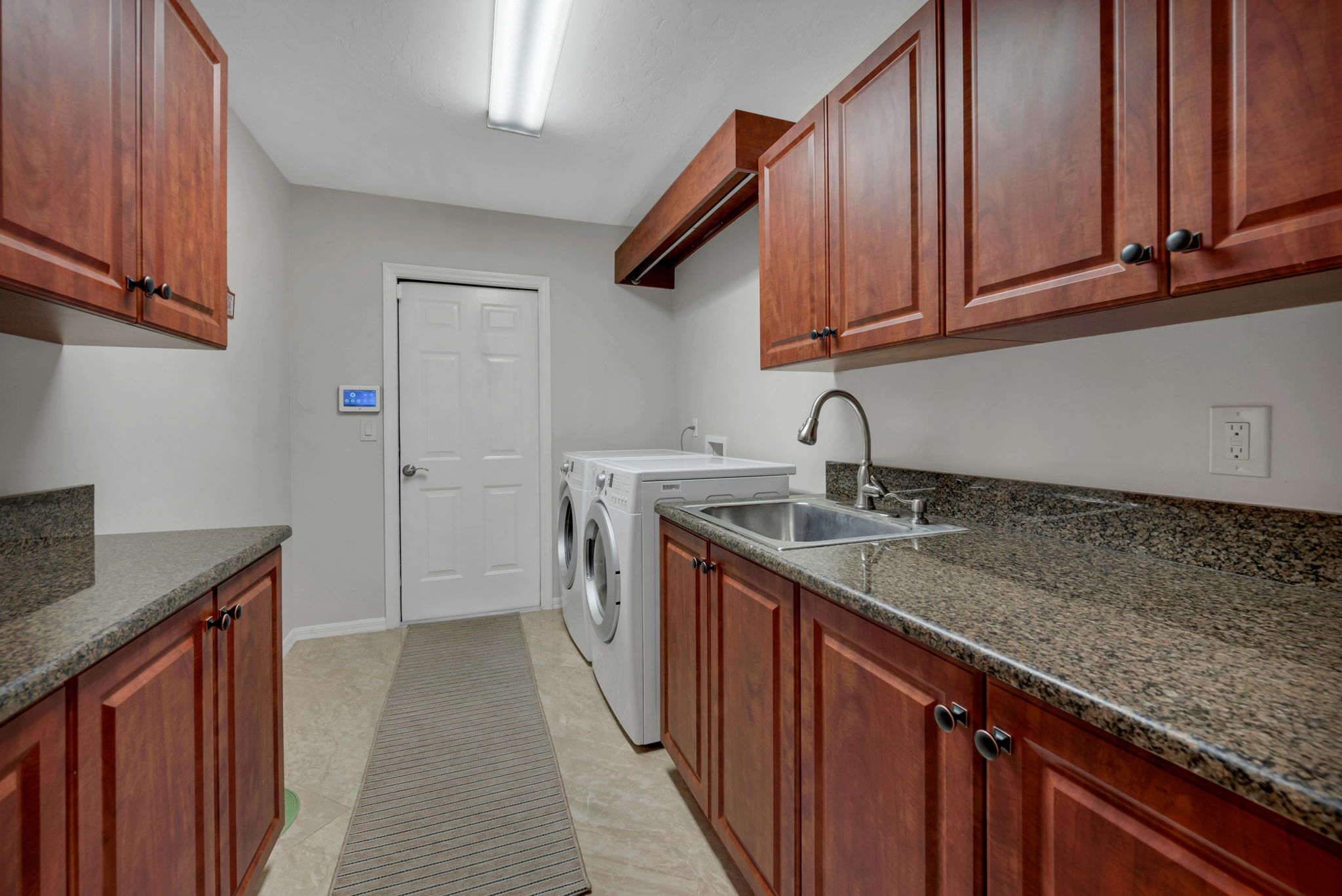 Laundry Room with plenty of storage and hanging rod