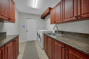 Laundry Room with plenty of storage and hanging rod