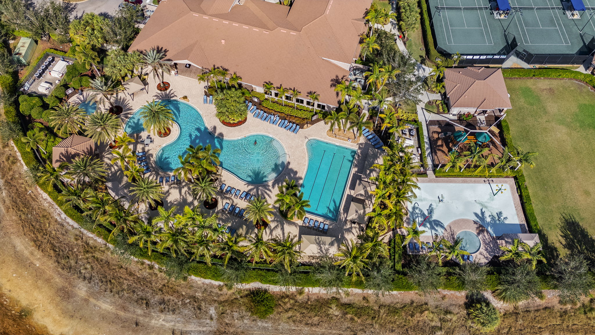 Impressive view of children's waterpark, lap pool, resort pool, tennis courts.