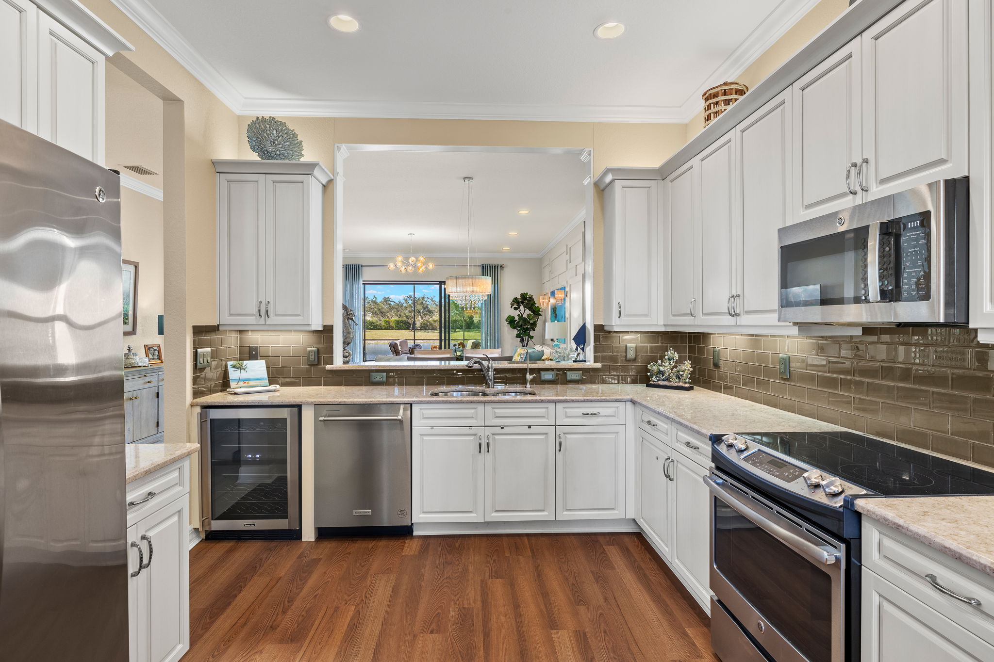 1 year new dishwasher and microwave! Built-in wine cooler! Above and below counter lighting! Enjoy the lake view from your kitchen sink!