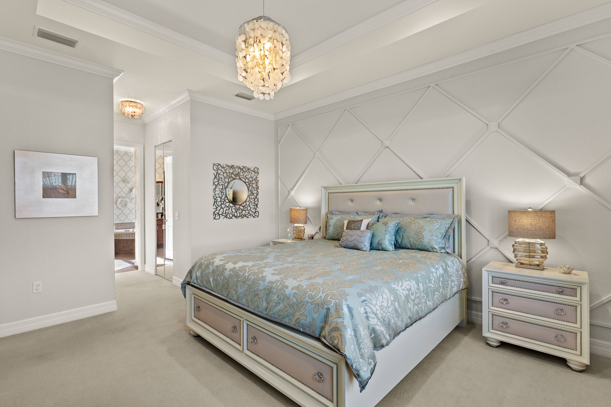 Tray ceiling, crown molding, to die for wood accent wall, mirrored closet His'N'Her walk-in closet doors combine to make a luxurious primary bedroom!