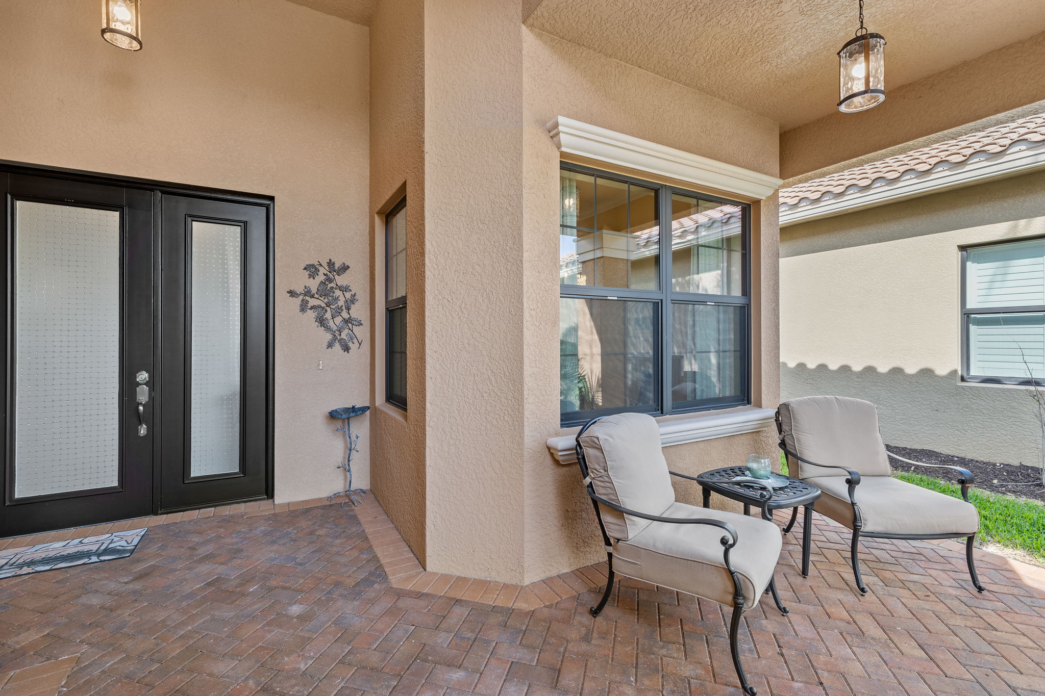 Entry door with oversized sidelight window makes for a grand entry into this fabulous home! Walkway to front door was widened! Impact resistant doors and windows throughout the home!!