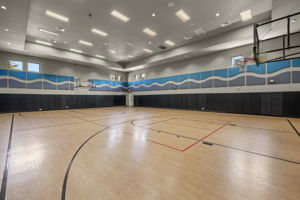 Indoor basketball court also has a pickleball net for additional pickle ball court...